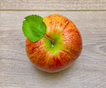 ripe juicy apple closeup on wooden background. top view - horizontal photo.