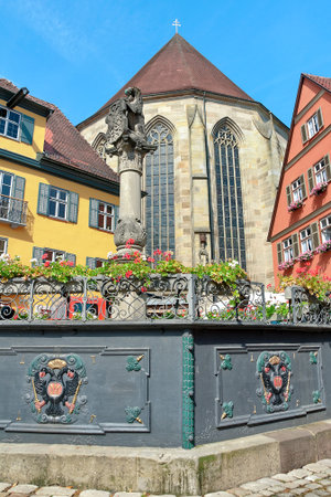 Dinkelsbuhl, Germany: Sculpture on the background of old buildings. Vertical photo.の写真素材