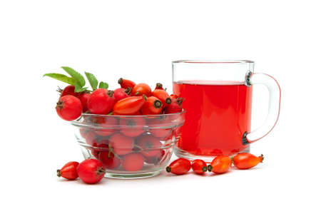 rose hips and hawthorn berries and drink in a cup on a white background. horizontal photo.の写真素材