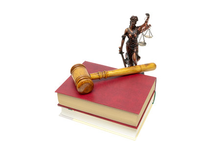 Justice statue, book and judges gavel on a white background. horizontal photo.