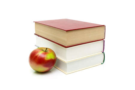 books and ripe apple on a white background. horizontal photo.の写真素材