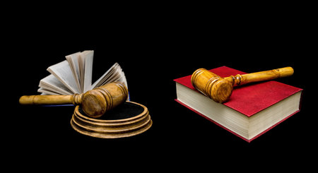 Judge's hammer and book on a black background. horizontal photo.の写真素材
