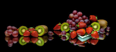 berries and fruits on a black background. horizontal photo.の写真素材