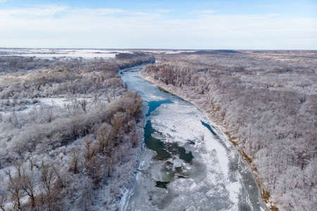 Winter forest. Frozen river, snow and frost. Aerial photography of the winter forest.の写真素材