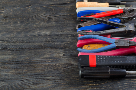 Tools on a black wooden background with structureの写真素材