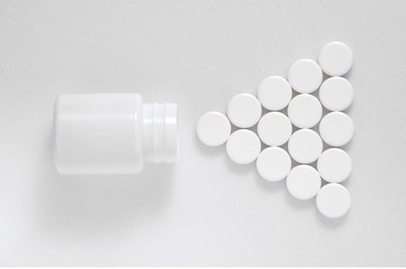 White packaging and white pills on a white background lined triangleの写真素材