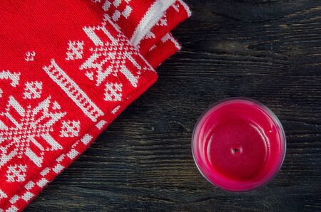 Candles and red plaid on a dark wooden backgroundの写真素材