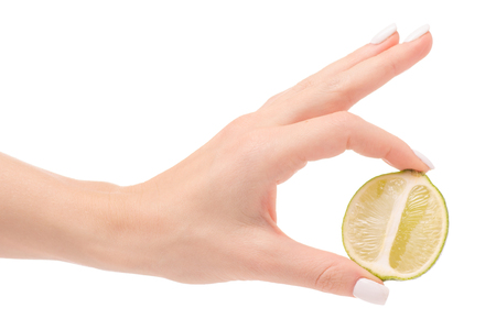Limes in hand on a white background isolationの写真素材