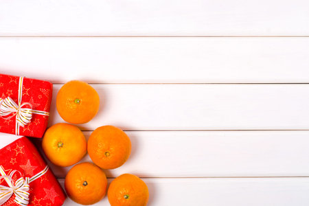 Christmas gifts boxes mandarin on a white wooden backgroundの写真素材