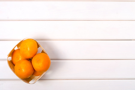 Mandarins cloth burlap on a white wooden backgroundの写真素材