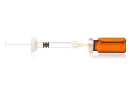 Glass Medicine  with medical Syringe isolated on white backgroundの写真素材