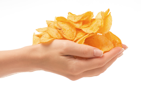 Chips golden snack female hand on white background isolationの写真素材