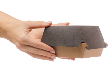 Box for a burger in a female hand on a white background isolationの写真素材