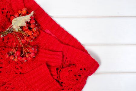Red sweater on a white wooden backgroundの写真素材