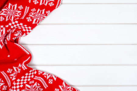 Red and white New Year winter blanket on a white wooden backgroundの写真素材
