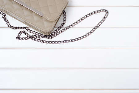 Lacquered ladies bag on a white wooden backgroundの写真素材