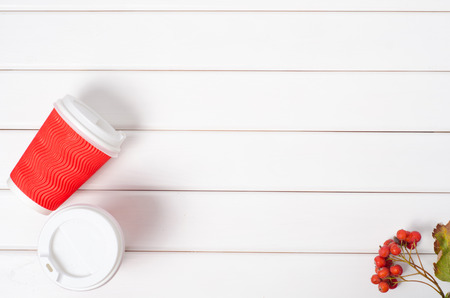 Two cups of coffee rowan viburnum flowers on a white wooden backgroundの写真素材