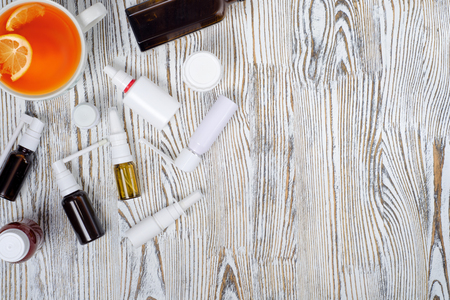 tea with lemon and pills medicine on a wooden backgroundの写真素材