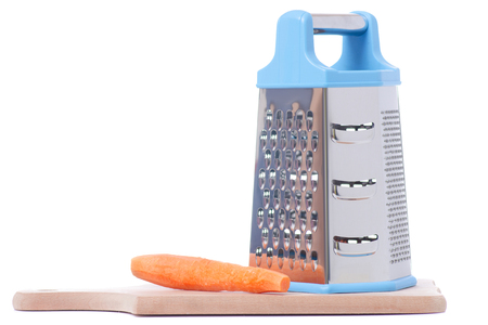 A kitchen grater and carrots isolated on white background isolationの写真素材