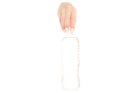 A bottle of water in female hand on a white background isolationの写真素材
