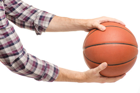 Basketball in man's hands on a white background isolationの写真素材