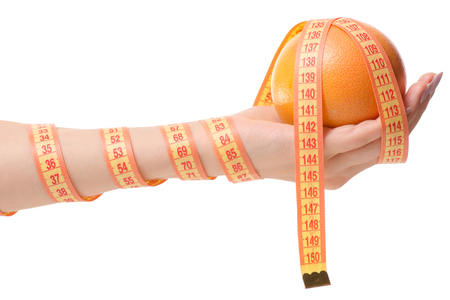 Grapefruit in hand health losing weight white background isolationの写真素材