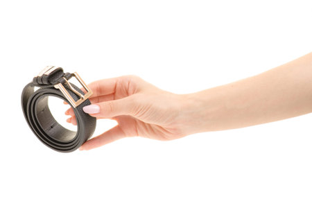 Female belt in a female hand on a white background isolationの写真素材