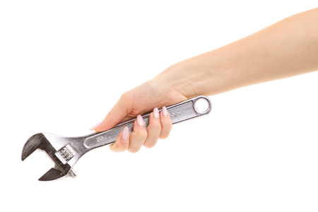 Adjustable wrench in a female hand on a white background isolationの写真素材