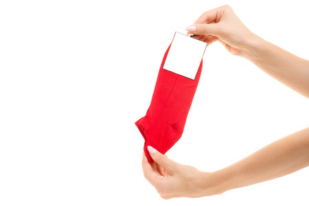 Couple of socks in a female hand on a white background isolationの写真素材