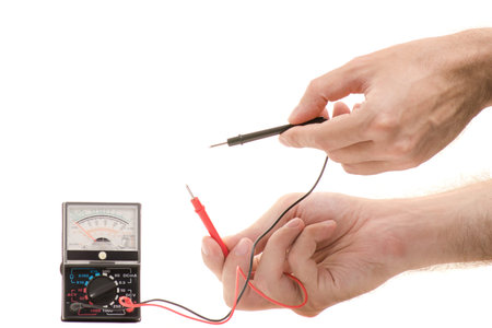 Multimeter analog in male hands isolated on white background isolation