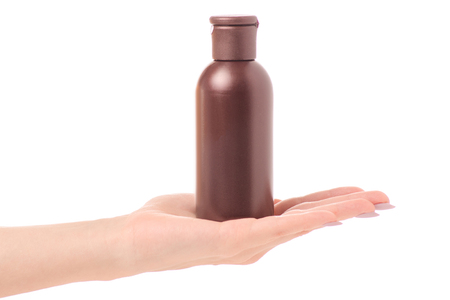 Bottle with cosmetics oil lotion female hands isolated on white background isolationの写真素材