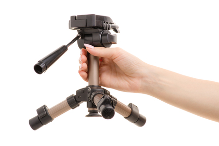 Small tripod in a female hand on a white background isolationの写真素材