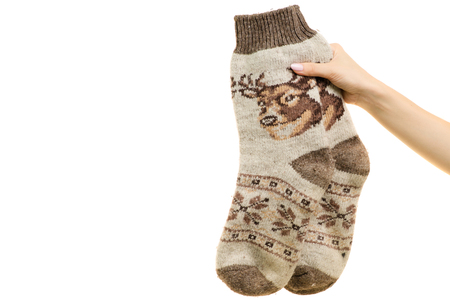 Knitted socks in female hands isolated on white background isolationの写真素材