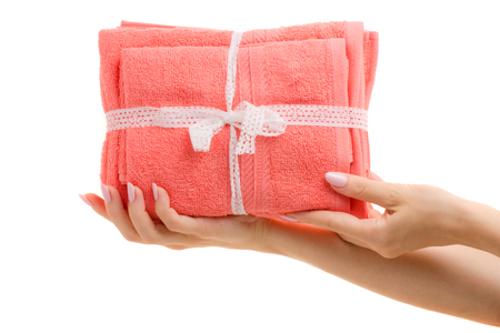 Set of towels in a female hand on a white background isolation giftの写真素材