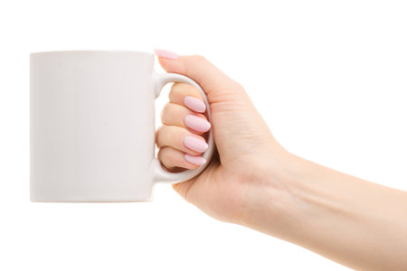 White mug in a female hand on a white background isolationの写真素材