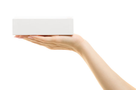 White box in female hand on white background isolationの写真素材