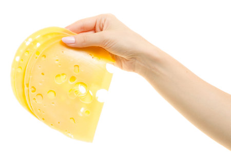 Slice of cheese with holes in female hands isolated on white background isolationの写真素材