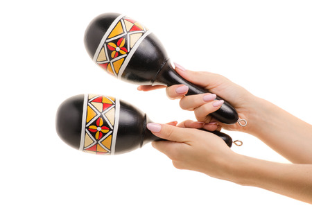 Maracas in female hands on white background isolationの写真素材