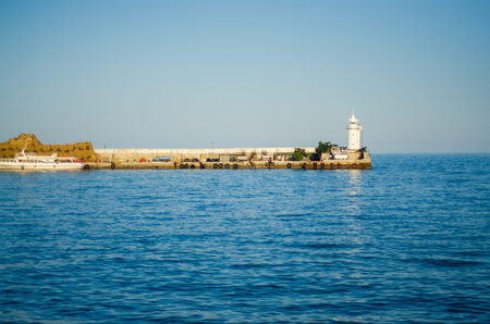 Wharf and lighthouse on the sea day natureの写真素材