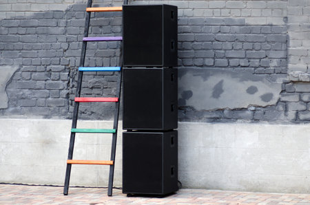 Black speakers on a brick wall background