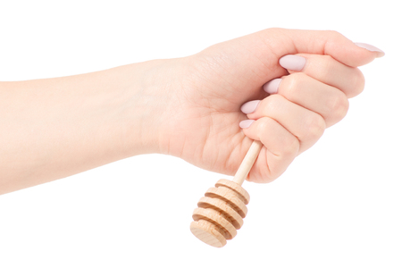 Spoon for honey in hand on a white background isolationの写真素材