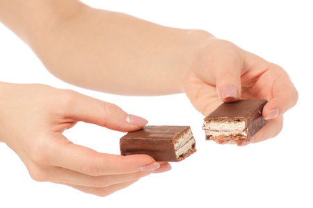 Chocolate cake candy biscuit milk in hand on a white background isolationの写真素材