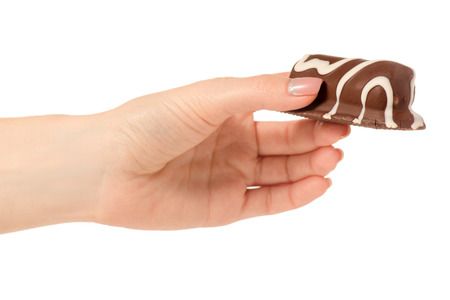 Cottage cheese curd  in chocolate glaze in hand on a white background isolationの写真素材