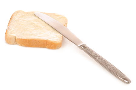 Bread with butter knife in hand on white background isolationの写真素材