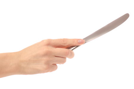 Table-knife in hand on a white background isolationの写真素材