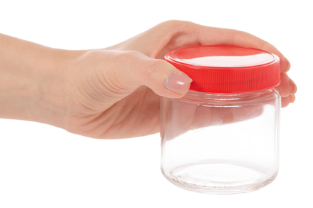 Glass empty jar with a lid in hand on a white background isolationの写真素材
