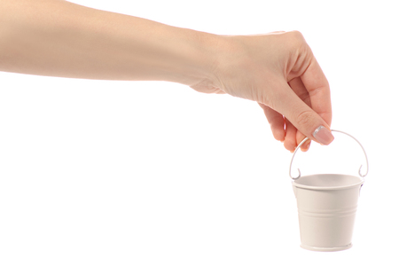Small white bucket in hand on white background isolationの写真素材