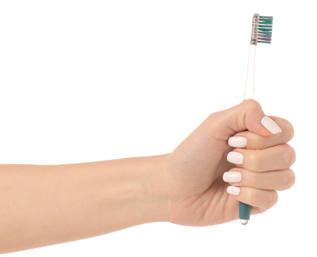 Toothbrush in hand on white background isolationの写真素材