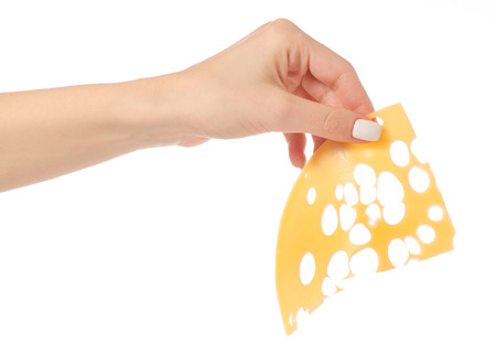 Sliced cheese on pieces in hand on white background isolationの写真素材