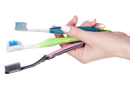 Toothbrushes in hand on a white background isolationの写真素材
